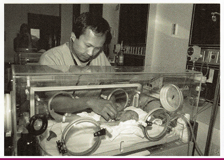 Dr Chai with Newborn in Baby Isolette